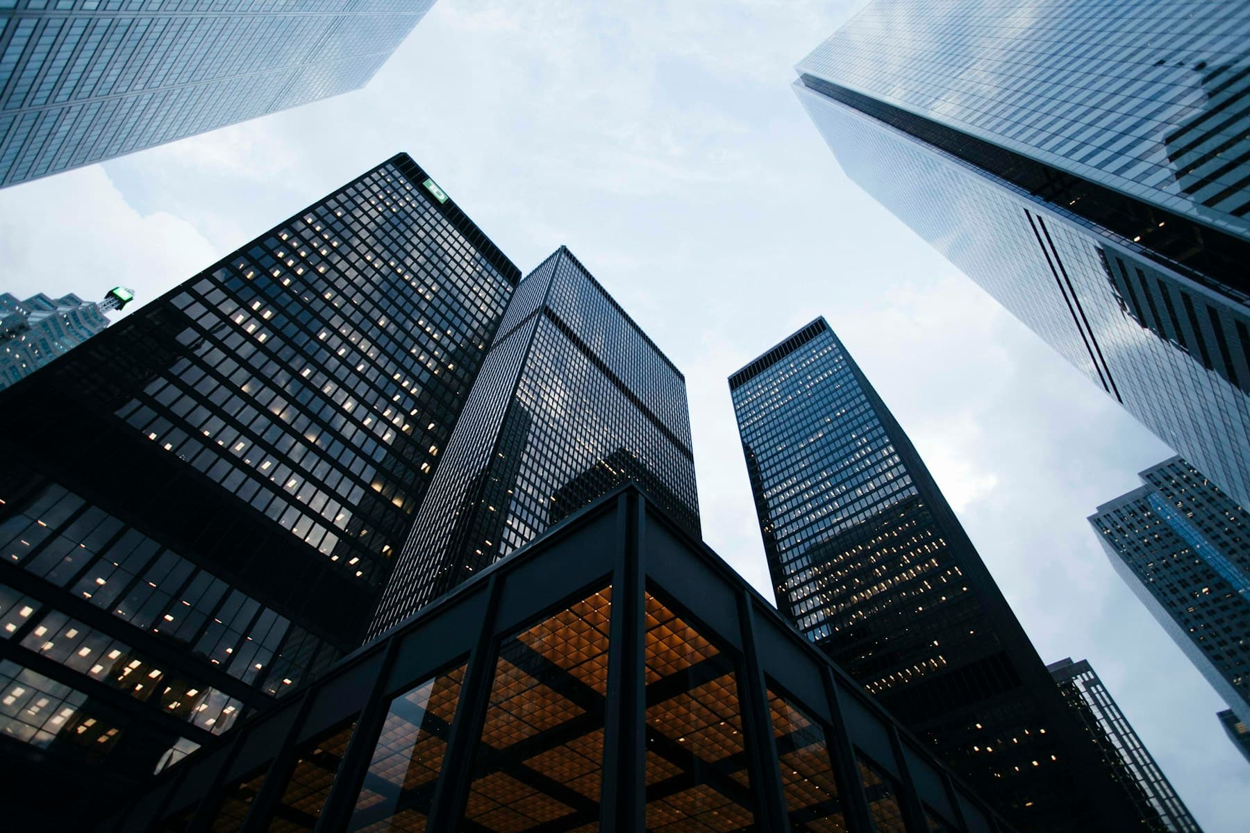 Modern glass buildings reaching toward an open sky